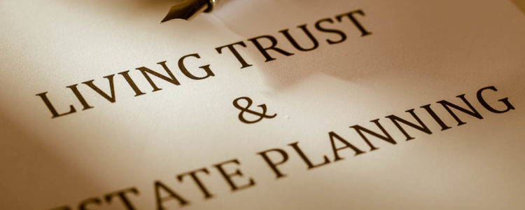 pen lying on a piece of paper that states living trust and estate planning